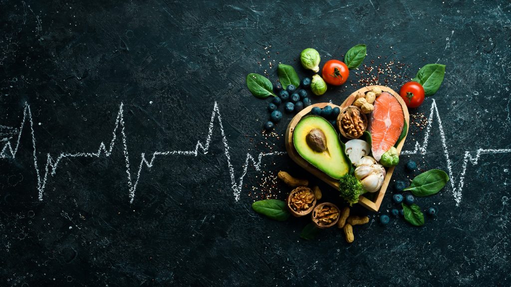 food-banner-healthy-foods-low-carbohydrates-food-heart-health-salmon-avocados-blueberries-broccoli-nuts-mushrooms-black-stone-background-top-view-min